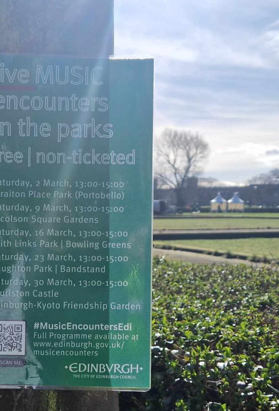 Music Encounters poster displayed on a street lamp in Leith Links