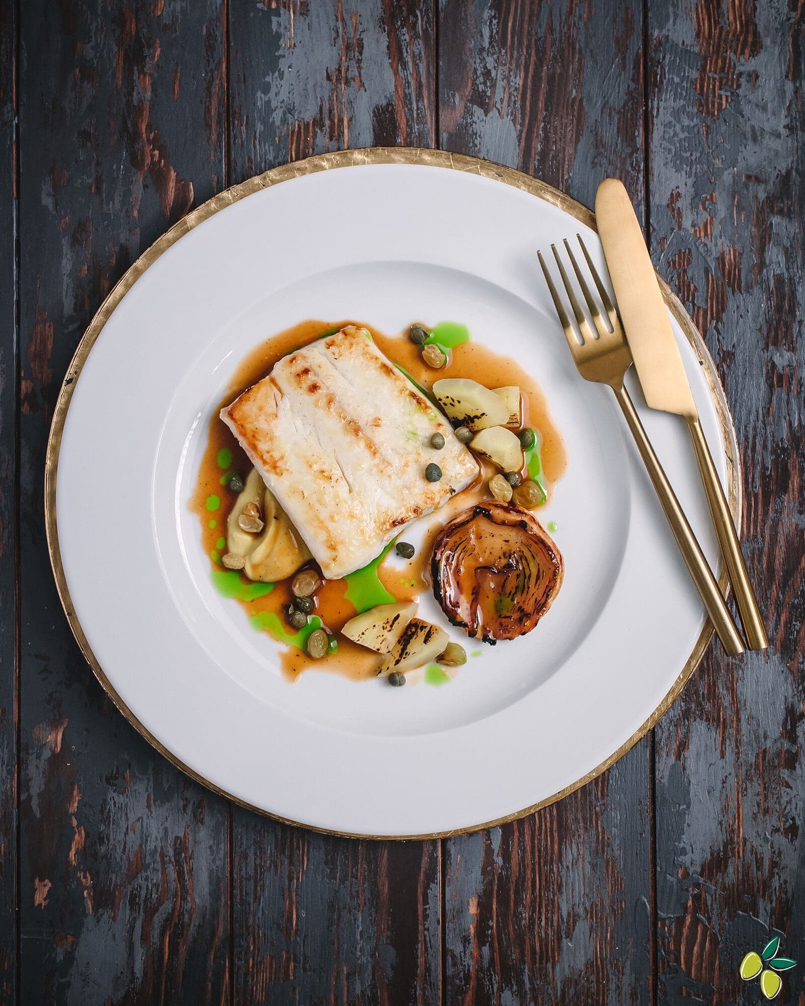 A plate featuring a serving of fish accompanied by a variety of colorful vegetables.
