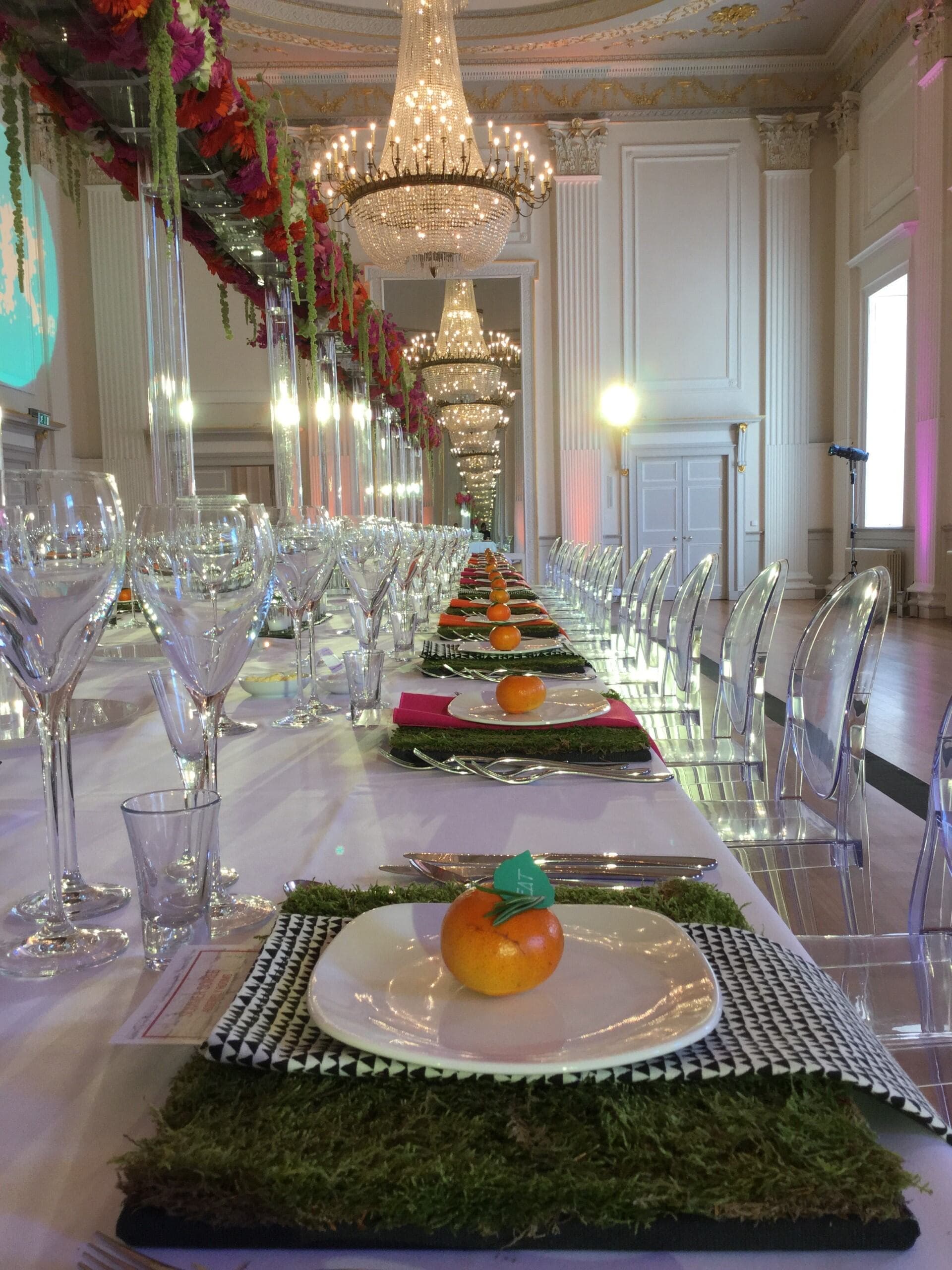 A lengthy table showcasing a diverse spread of food and wine, ready for guests to enjoy a communal dining experience.