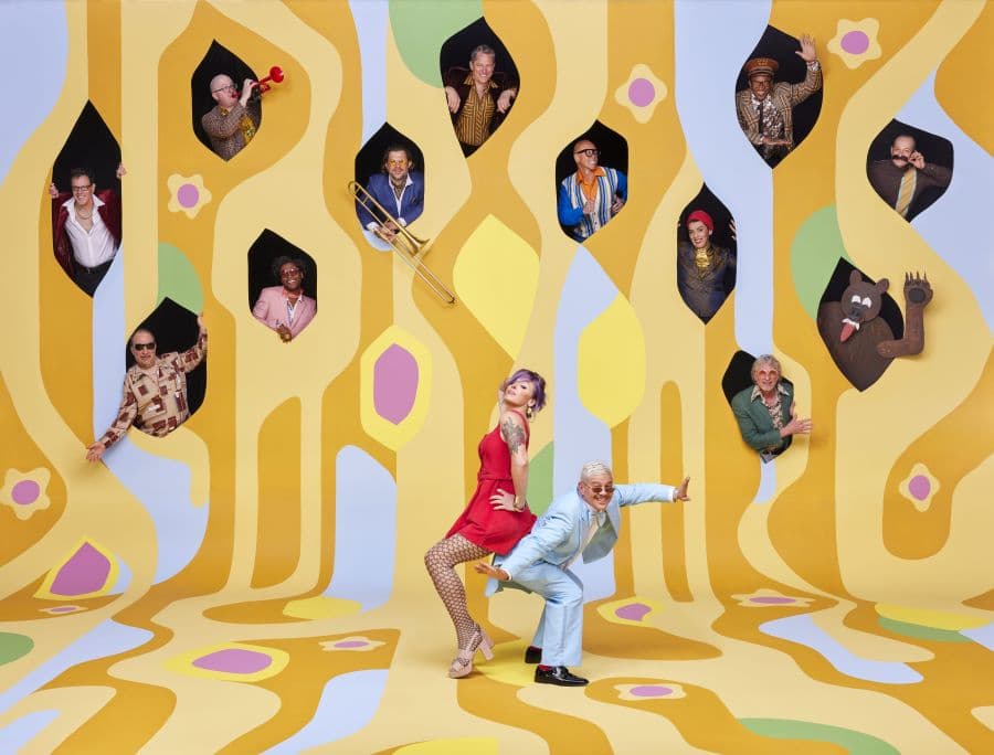 Image shows band members with funky yellow backdrop 
