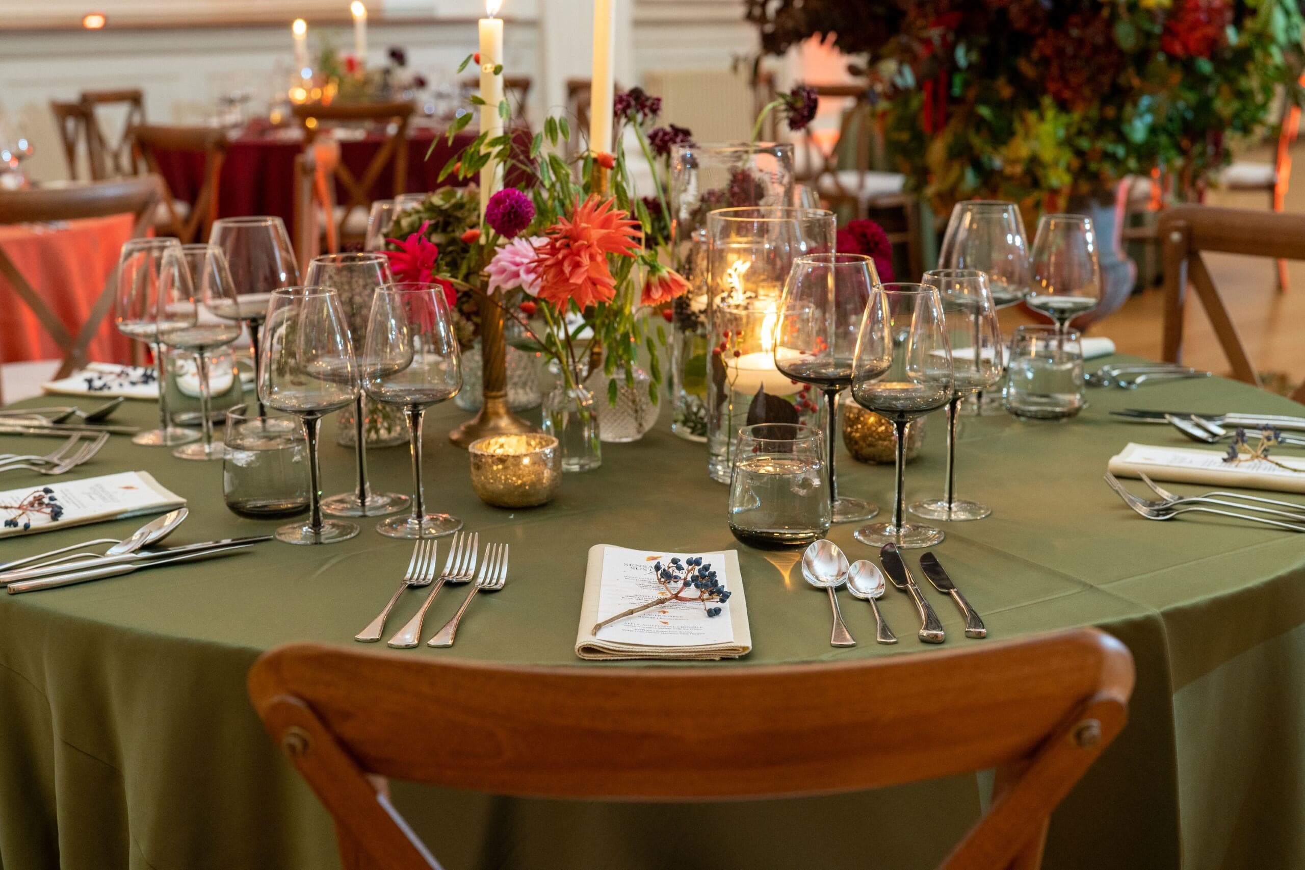 A table draped in a lush green cloth, creating a fresh and inviting atmosphere.