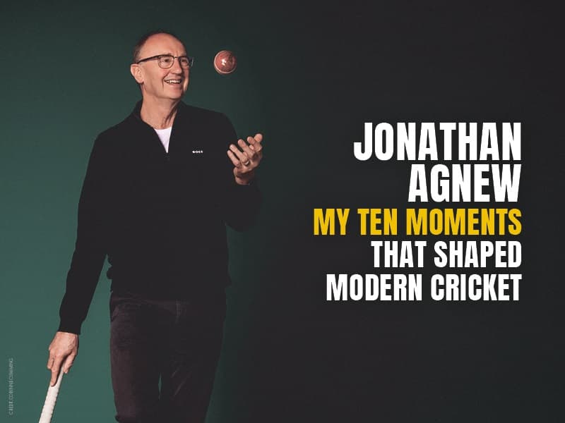 Jonathan Agnew smiling throwing a cricket ball in the air whilst holding his bat