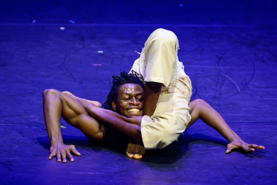 Contortionist performer bending his body into flexible position