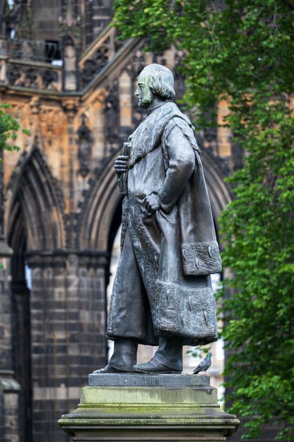 Side profile of Adam Black statue next to the Scott Monument