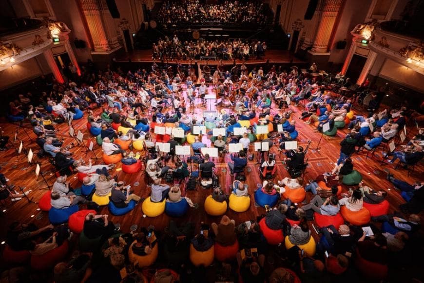 BEANBAG CONCERT SERIES  Explore Dmitri Shostakovich’s Fifth Symphony as Aurora Orchestra unpacks its drama, depth and defiance.  Discover Shostakovich’s Fifth Symphony in a fresh and immersive way. Through a conversational presentation, founder-conductor Nicholas Collon and Aurora Orchestra explore the piece, pausing to share insights and delve into its emotional depth and historical context.  Composed in 1937 following a scathing Pravda review, the symphony was Shostakovich’s response to Joseph Stalin’s regime. From the militaristic drive of the outer movements to the poignant Largo, the work is rich in both emotional complexity and musical innovation.  This beanbag concert offers an opportunity to experience the symphony in an intimate setting, allowing you to explore its powerful narrative and intricate composition like never before.