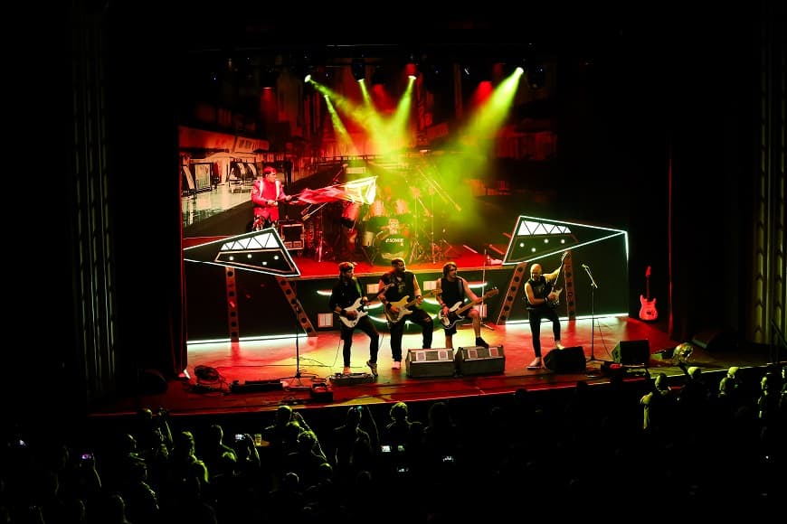 Image of Beast UK performing on stage