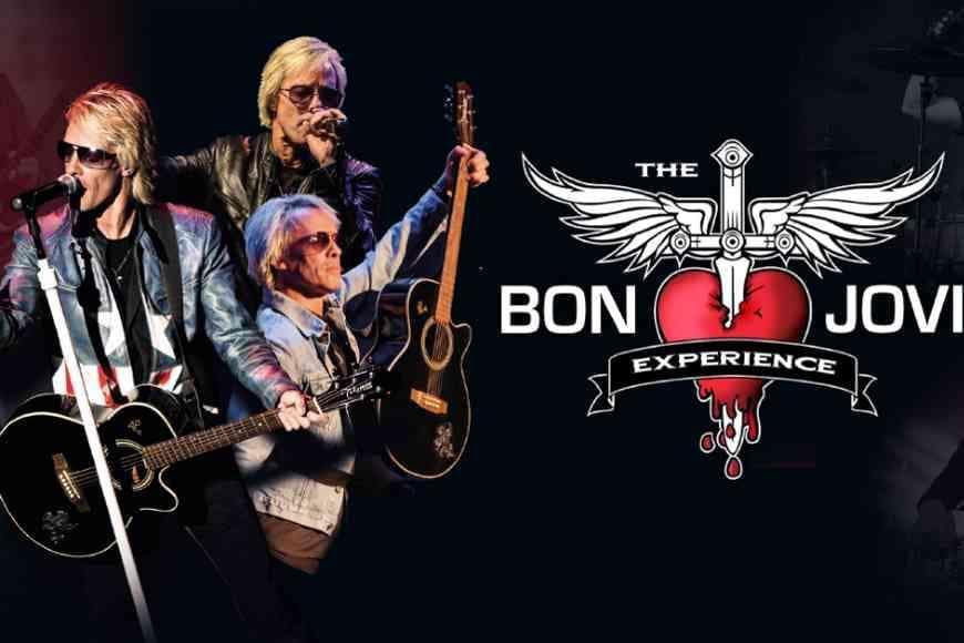 Man dressed as Bon Jovi singing into microphone and playing guitar