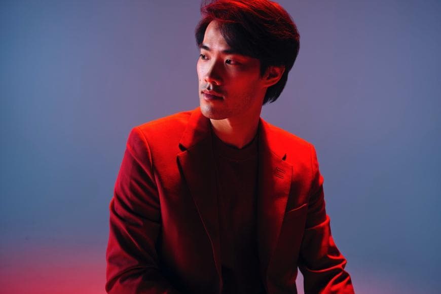 Photo of Bruce Liu wearing red suit