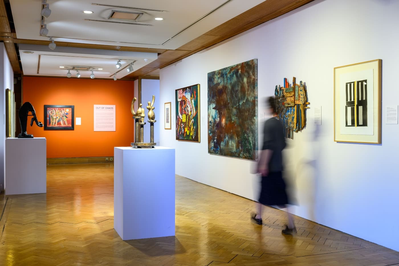 Blurred person exploring city art centre exhibition