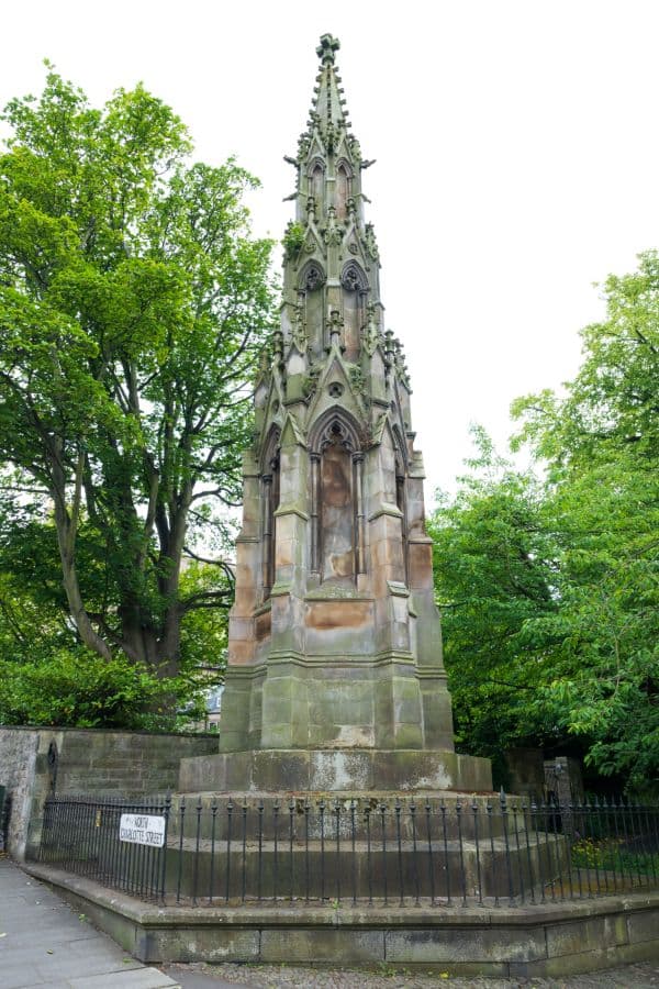 Tall gothic style monument surrounded by trees