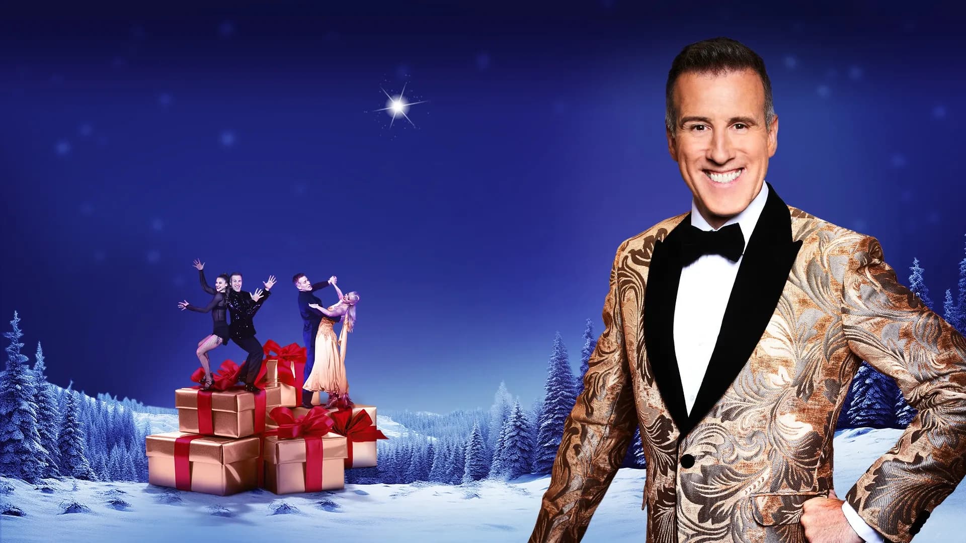 Anton in formal wear, in front of a night time christmas scene with reindeer and presents