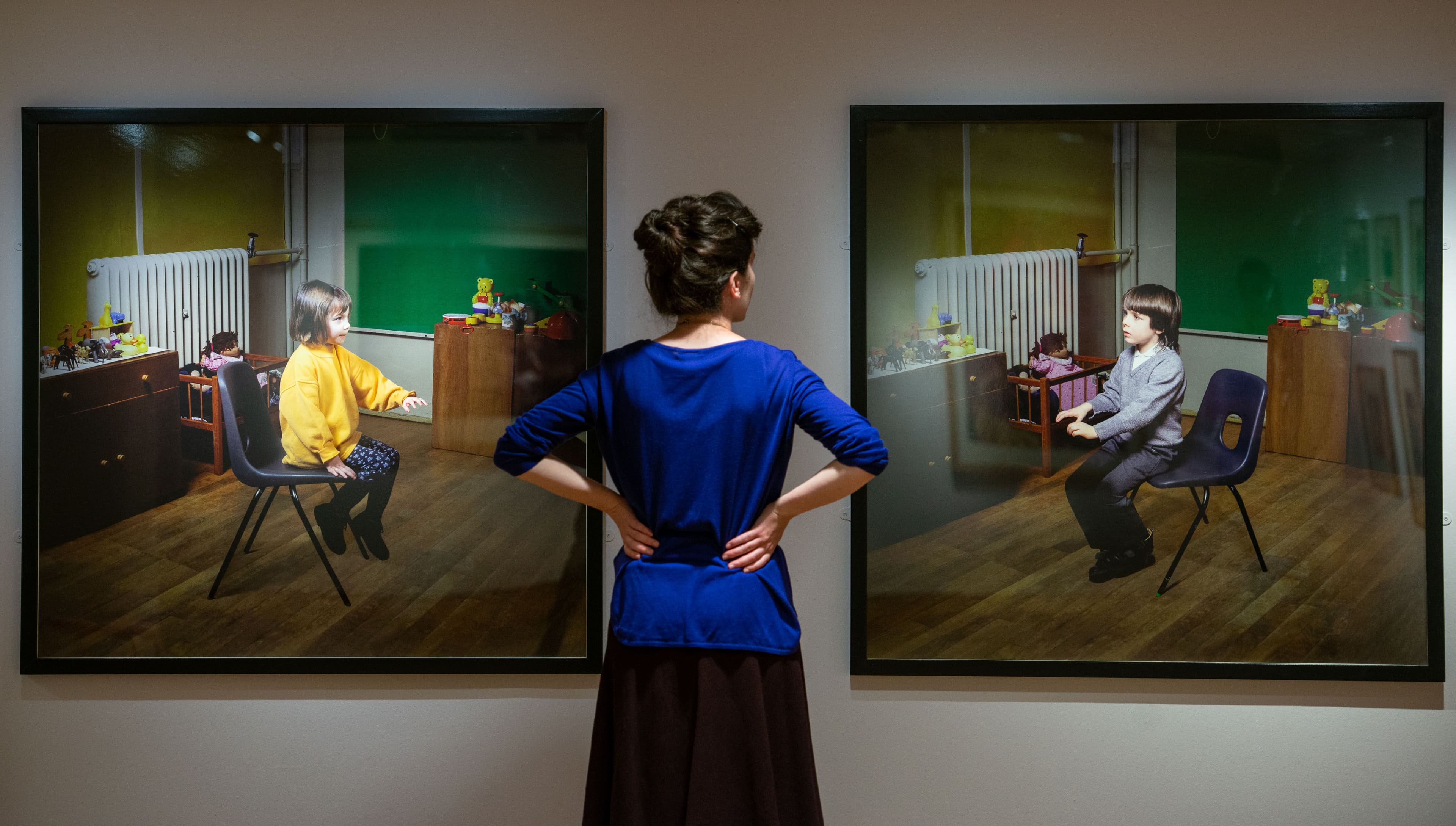 Lady stood looking at 2 city art centre paintings