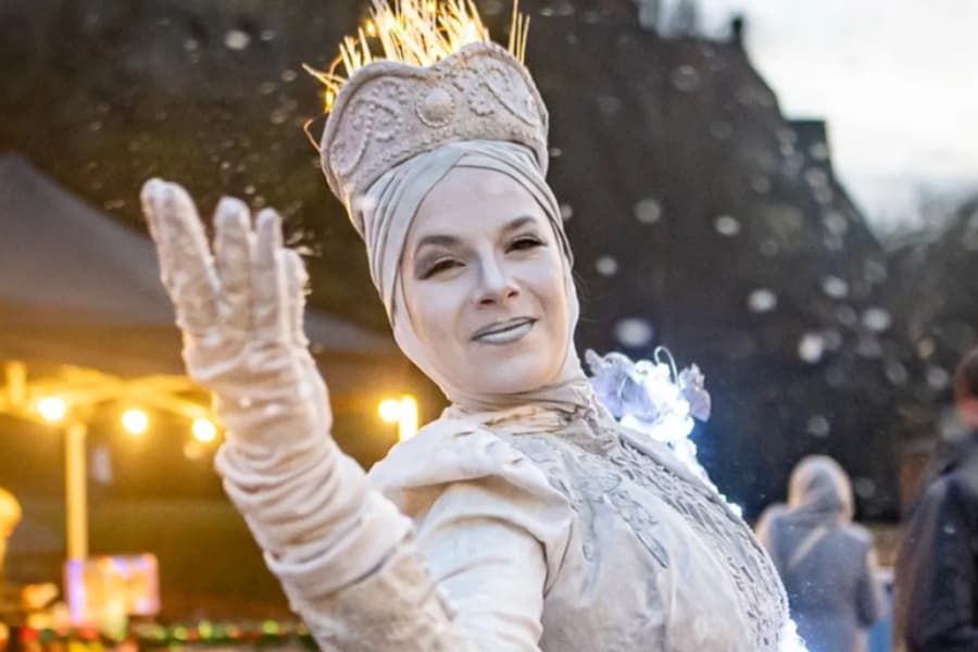 A woman wearing a white Snow Queen costume