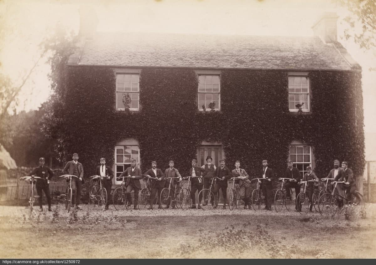 Vintage photo of men standing next bicycles