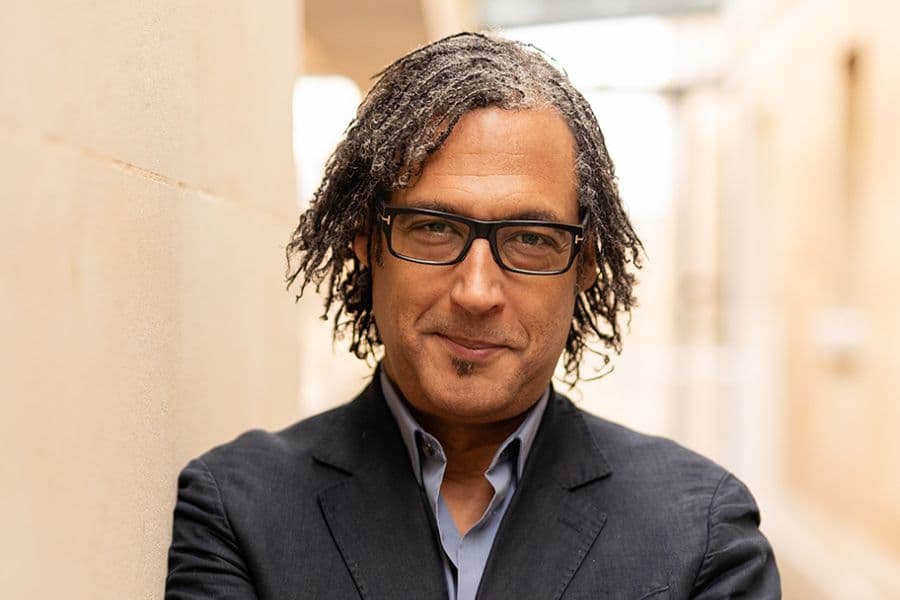 Image shows David Olusoga smiling