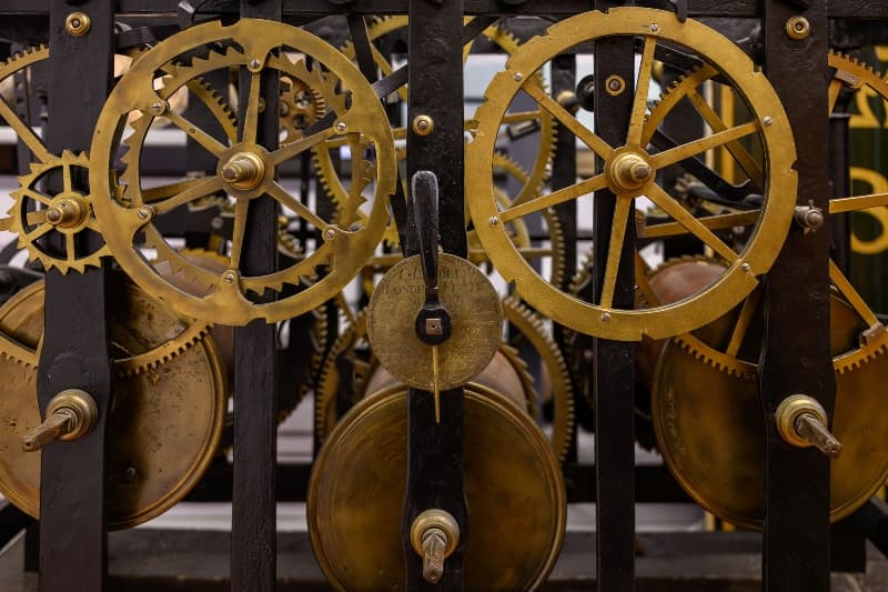 Close-up of a vintage clock mechanism displayed in Edinburgh's Museum Collections Centre, showcases intricate craftsmanship.
