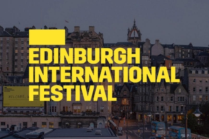 Yellow All CAp text saying EDINBURGH INTERNATIONAL FESTIVAL on a background of the Edinburgh skyline