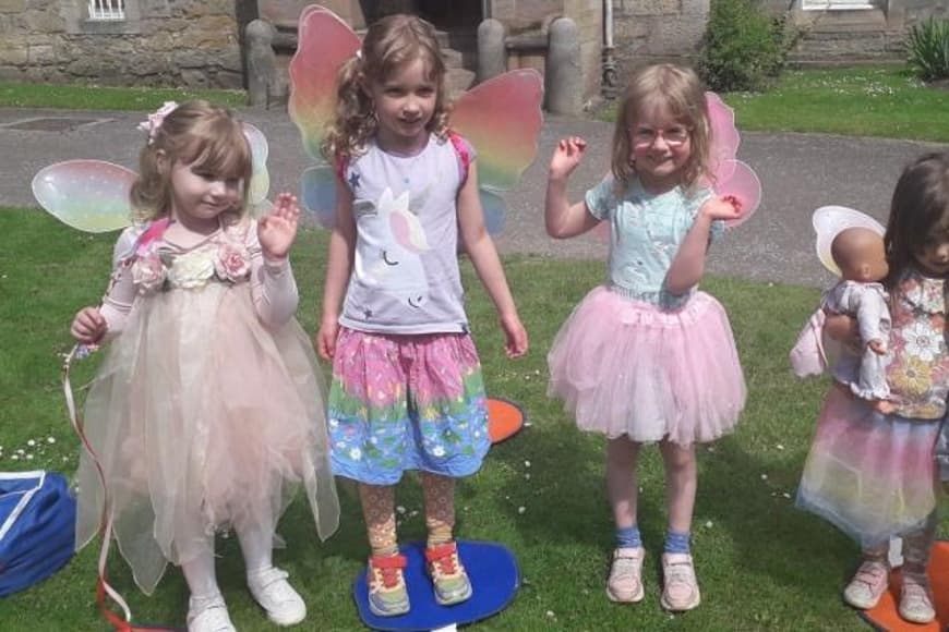 Young girls dressed in pink fairy outfits