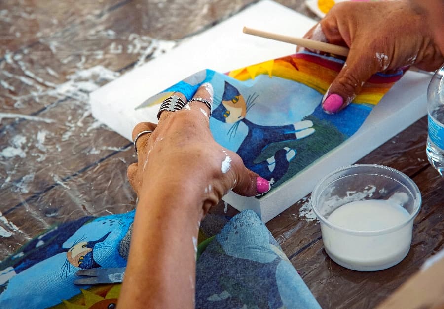 Phot of hands creating an abstract artwork with paper  cutout