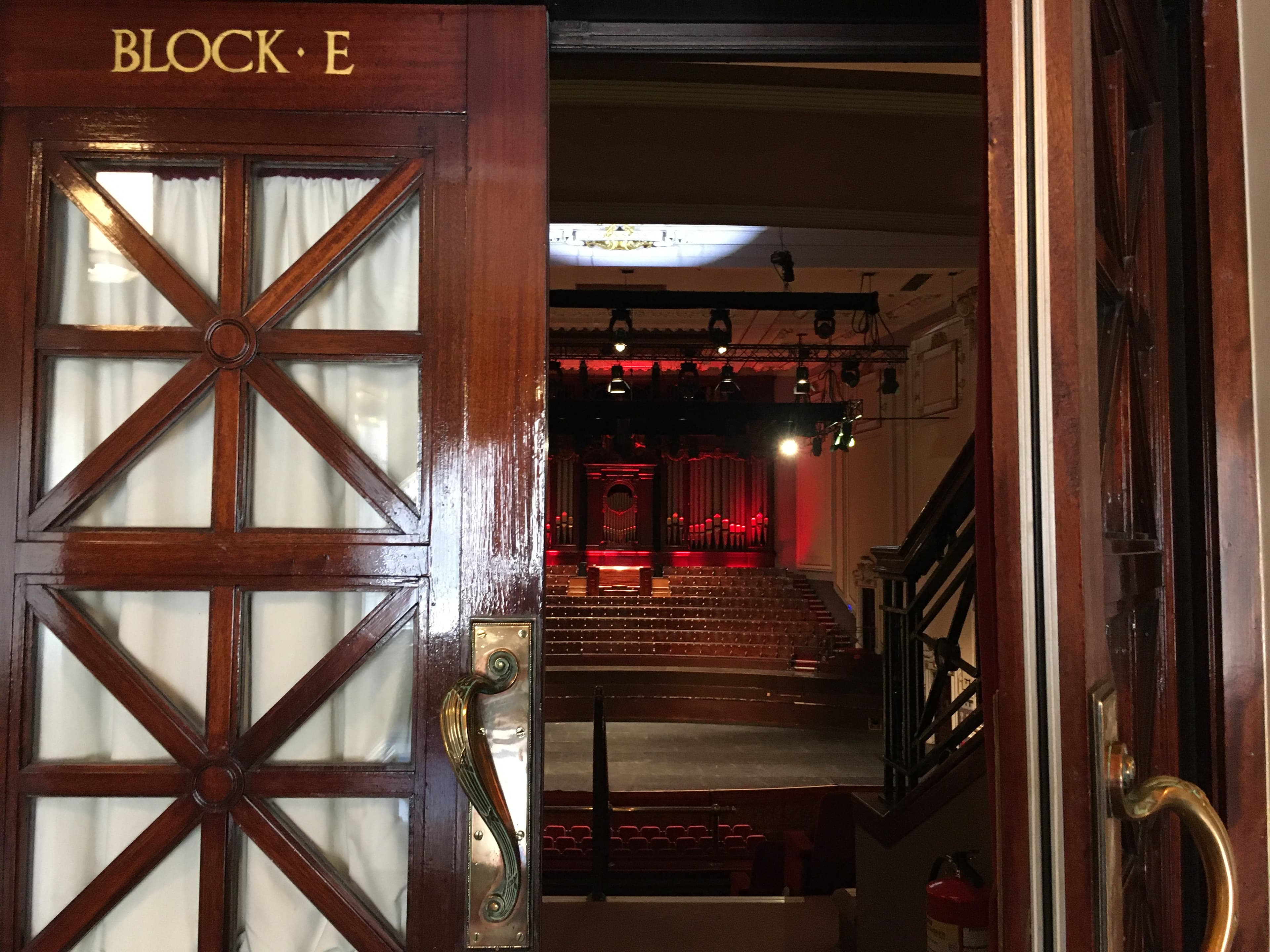 The entrance of Block E Theatre, highlighted by sleek architecture building features. The stage is seen through this entrance in the distance