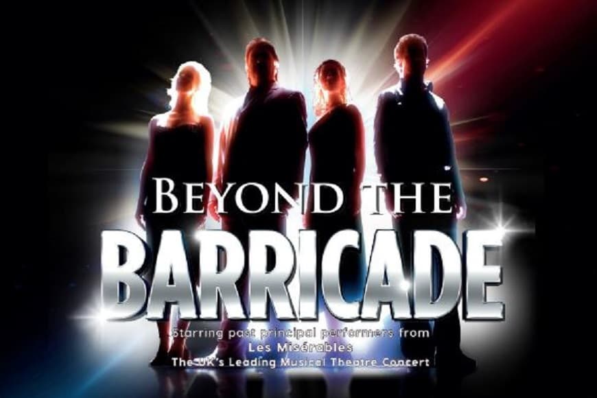 Beyond the Barricade band members stood in front of the stage lights 