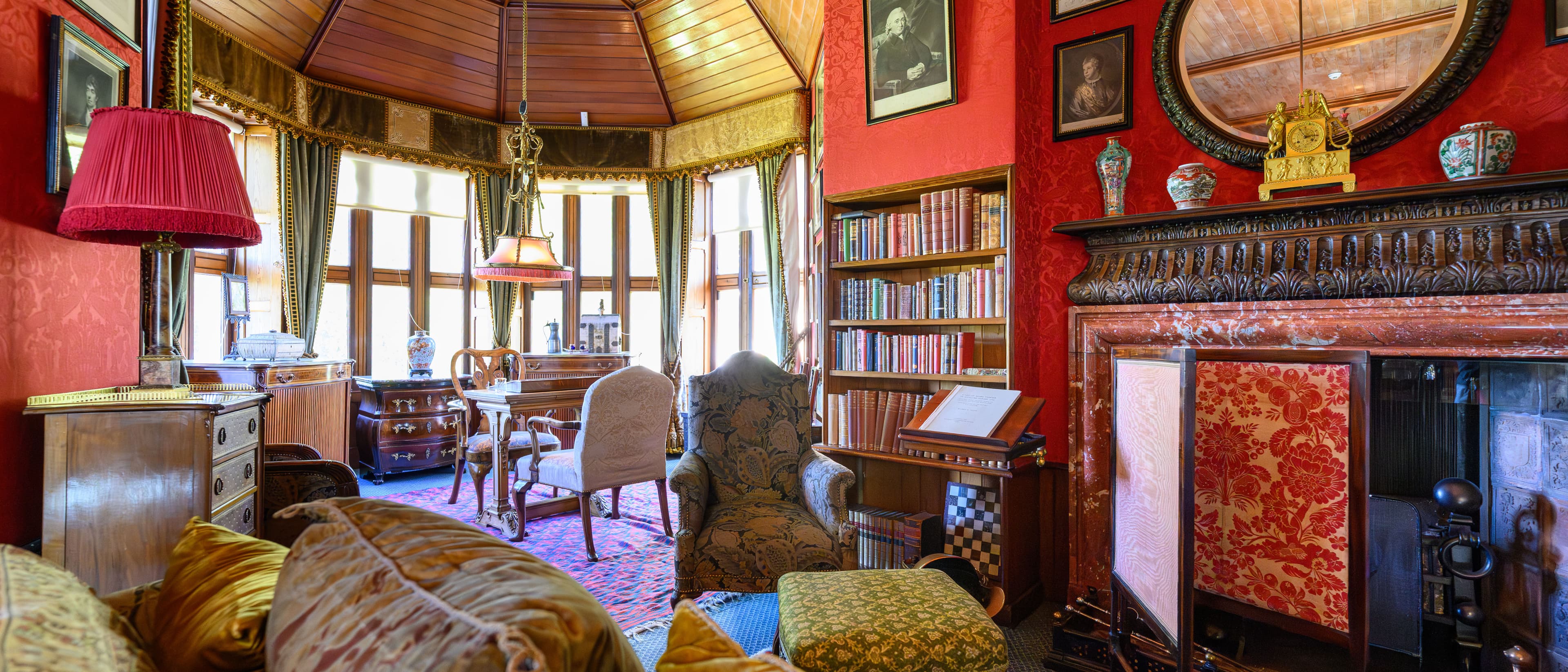 An interior of the Castles sitting room. Lovely chairs and a marble fireplace