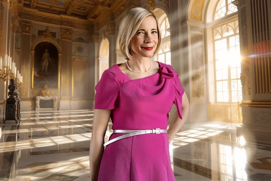 Image of Lucy Worsley smiling wearing pink dress