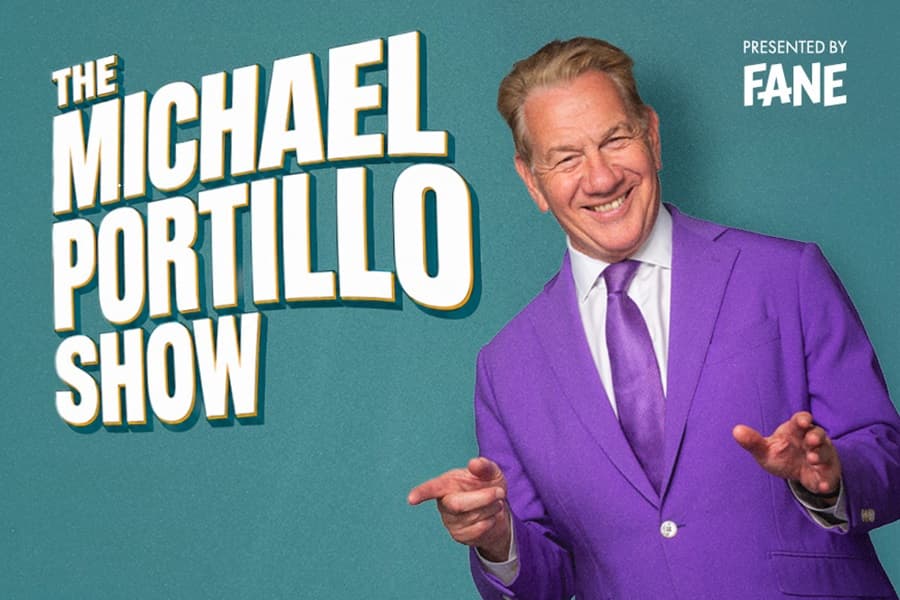 Image shows Michael Portillo smiling wearing purple suit