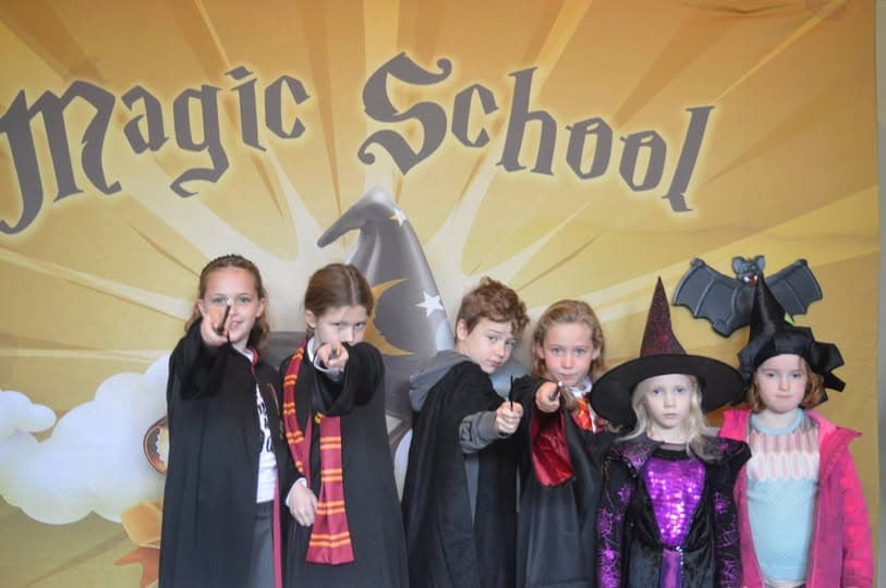 Young children dressed as wizards and witches