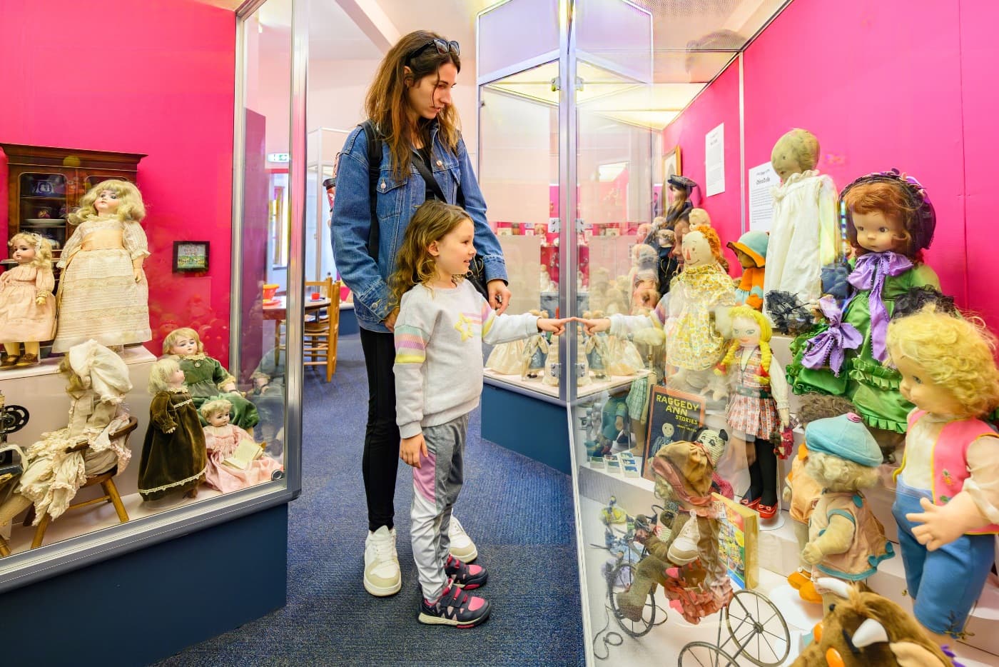 Mother and daughter looking at dolls