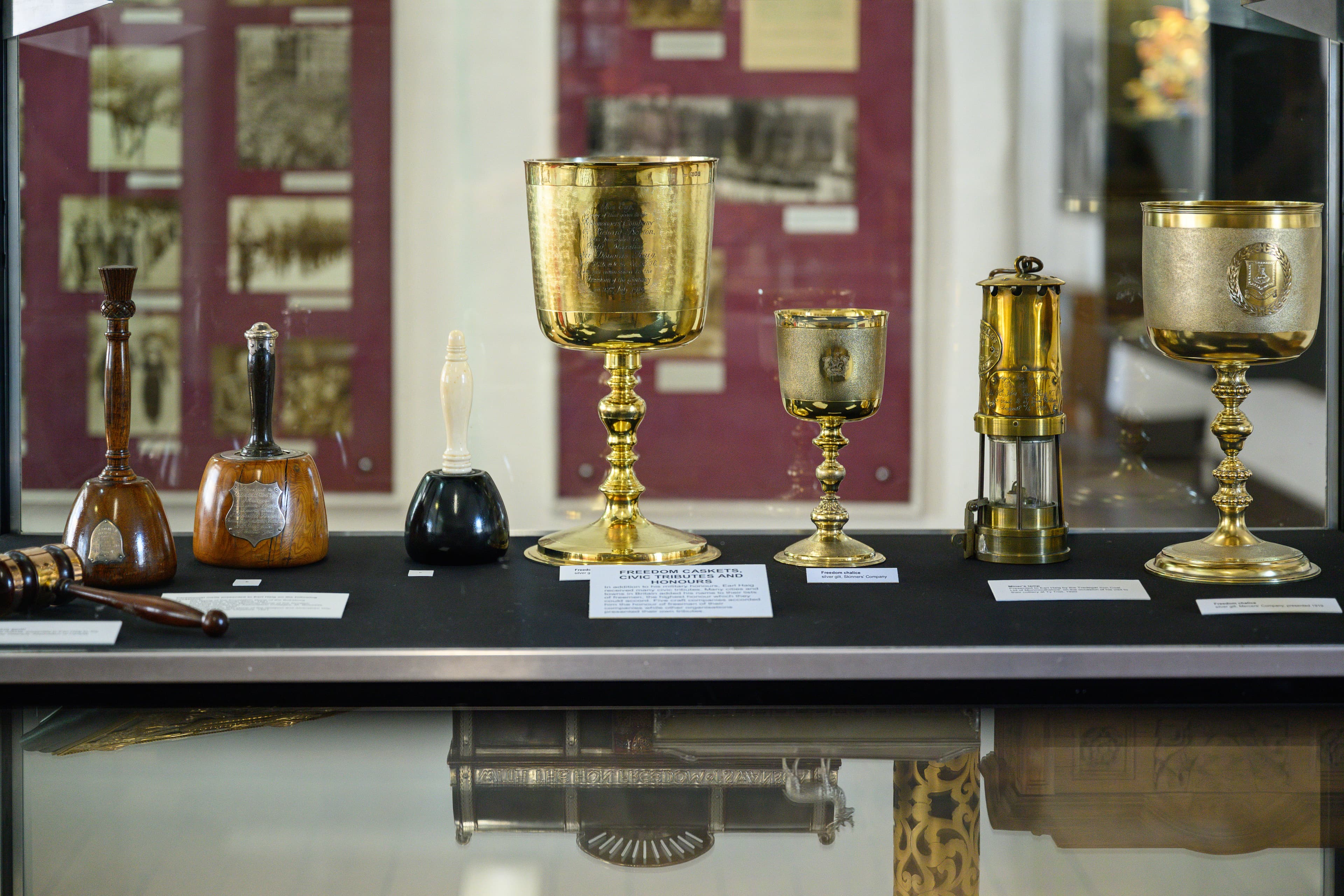 A showcase filled with diverse items, such as utensils, goblets, and decorative objects, arranged for display.