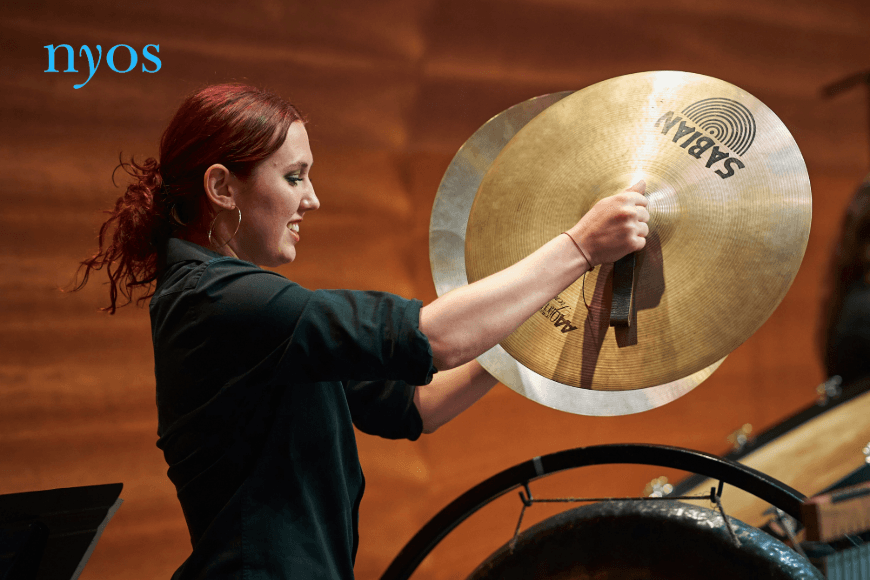 Image of young person playing cymbals