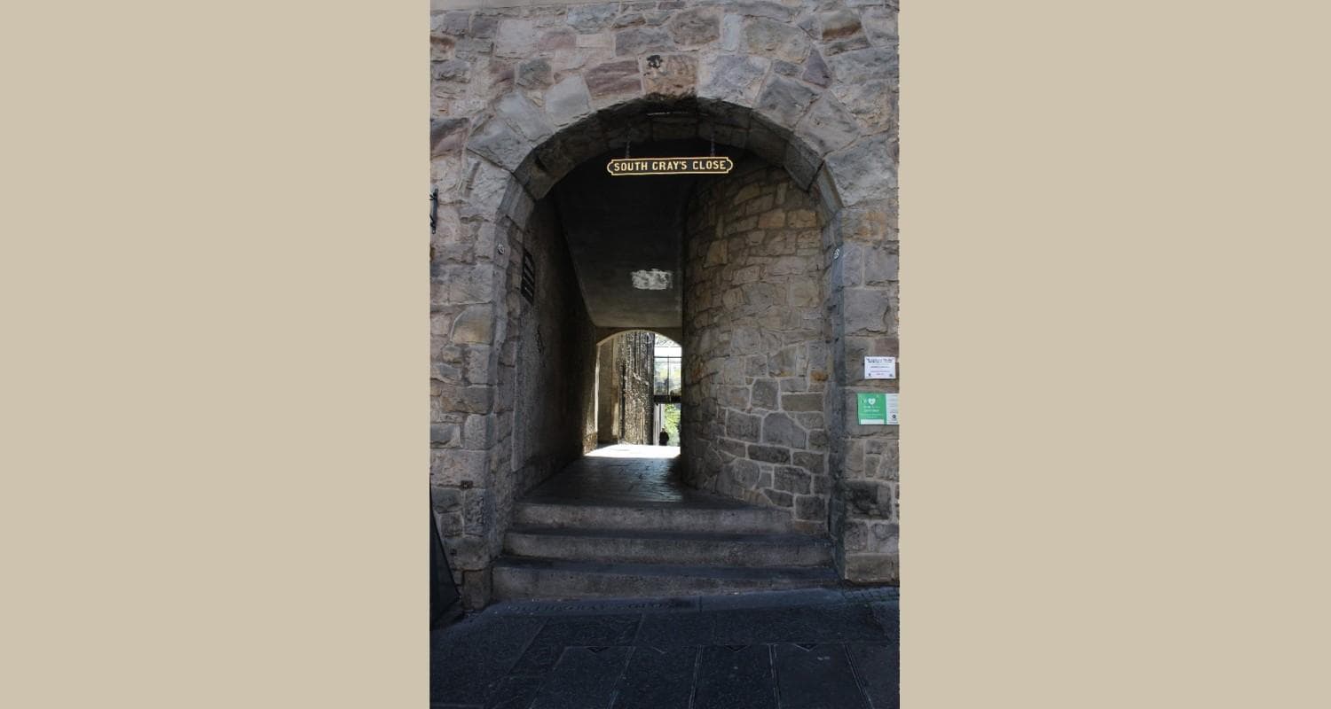 A rustic stone archway - the entrance to South Gray's Close in Edinburgh