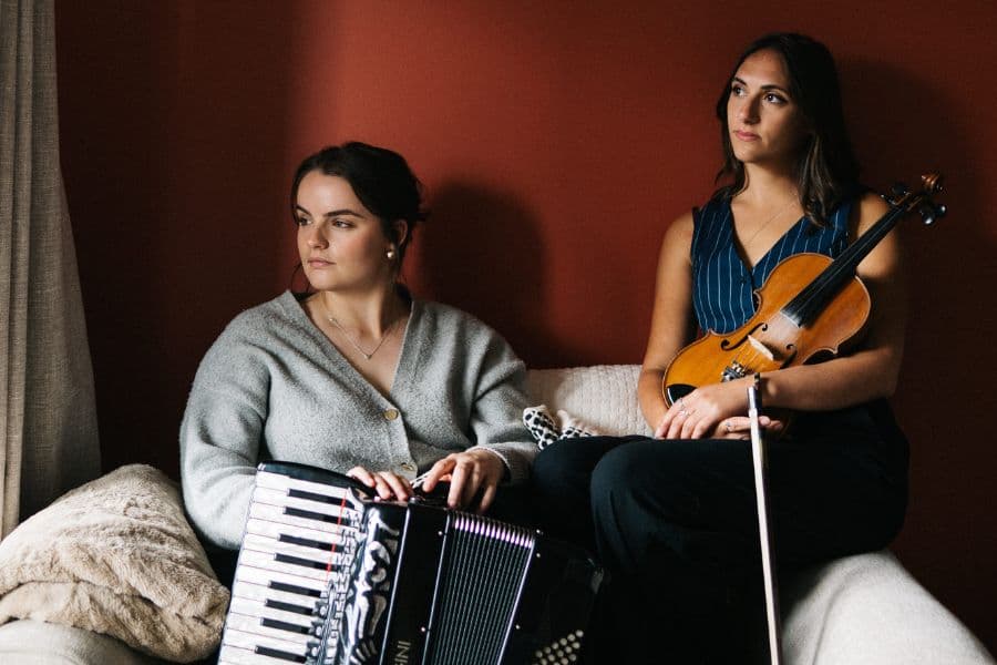 Image shows two women posing with fiddle and accordion 