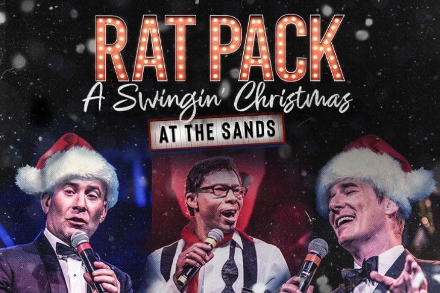 Men singing into microphones wearing Santa hats