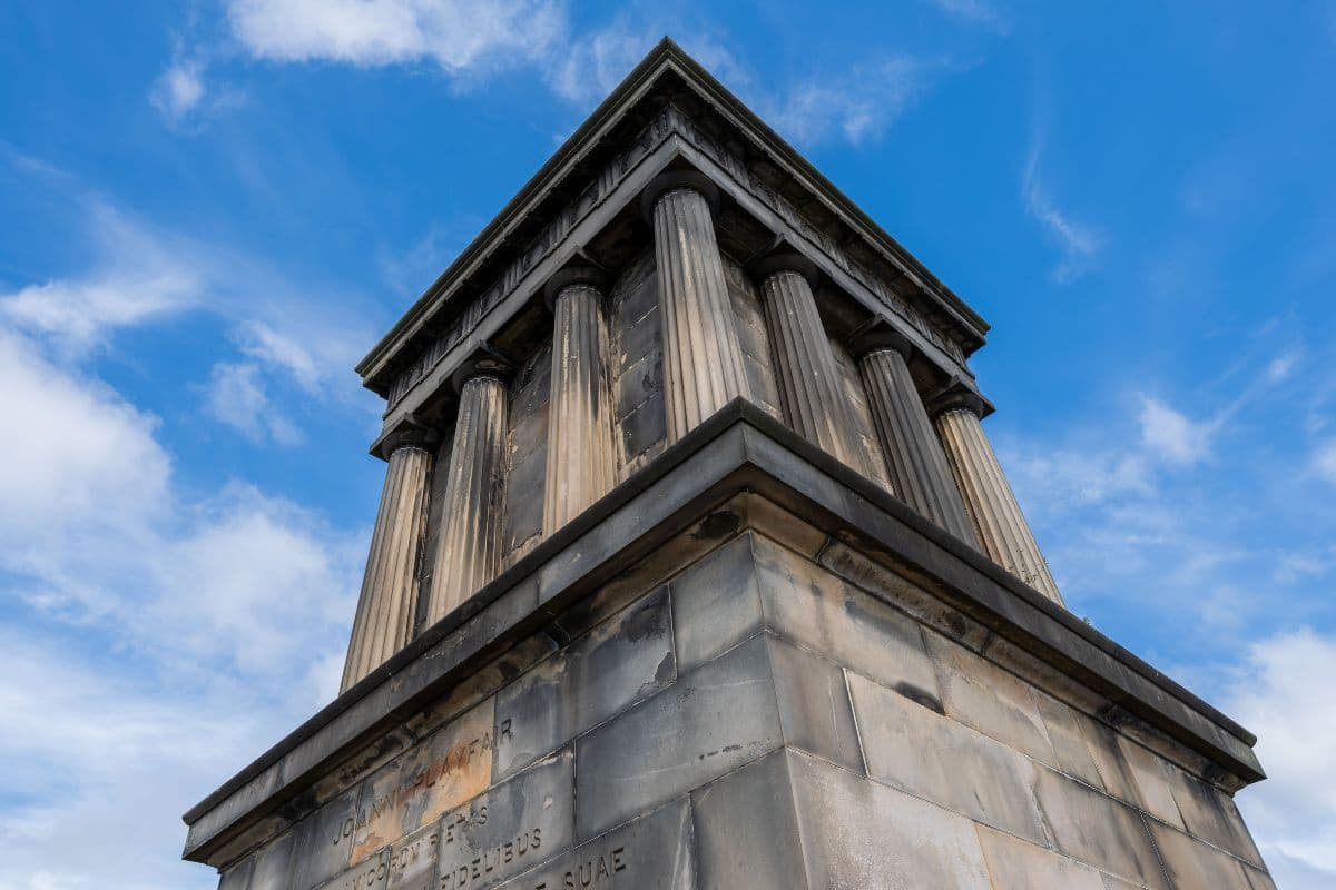 Closeup upward angle of a large Greek/Roman style monument with pillars