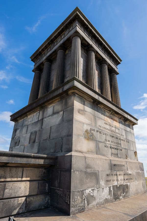 A Roman style monument with columns on a clear sunny day