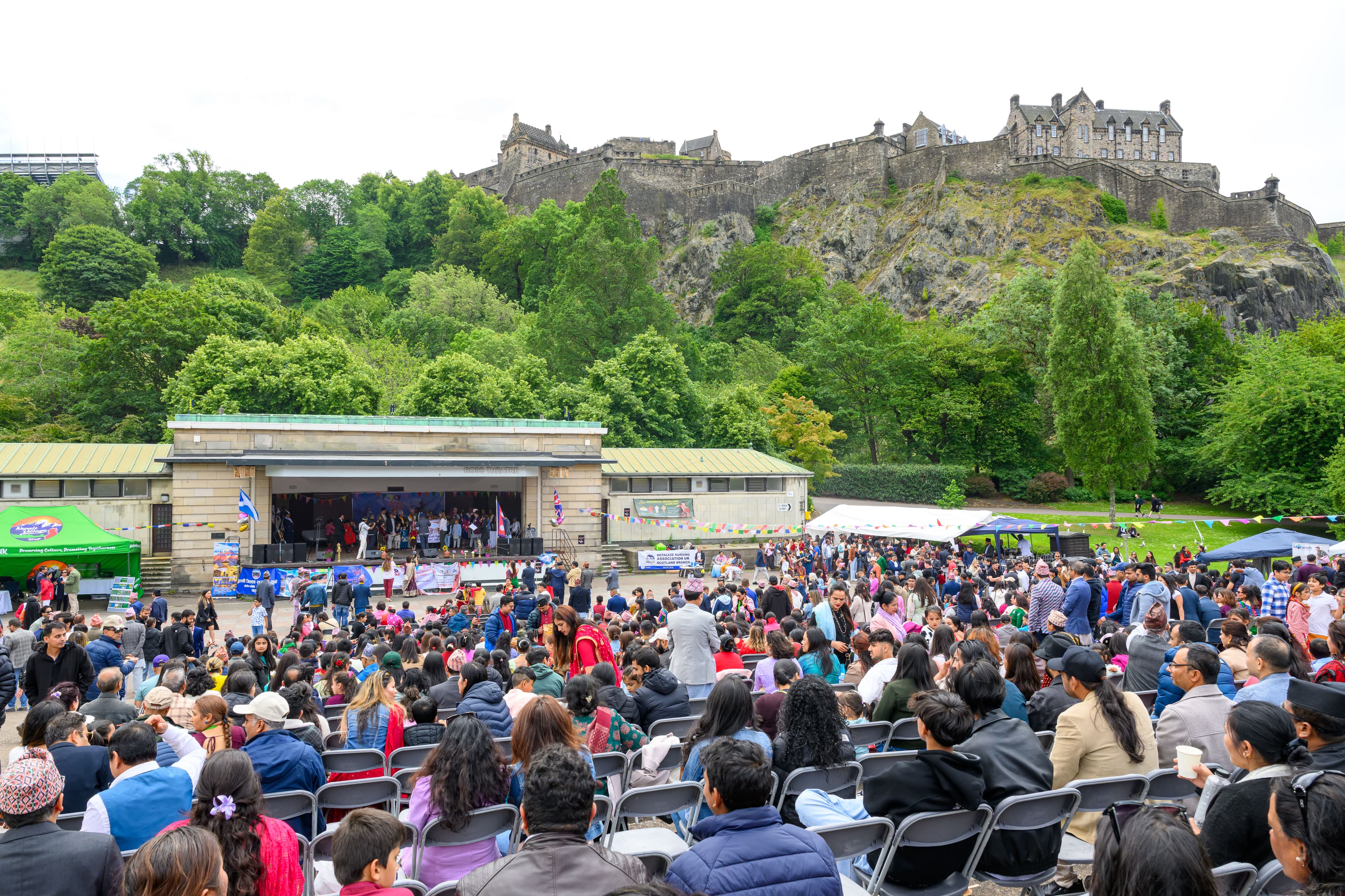 Ross band stand crowd watching a show on the stage beneath edinburgh castle