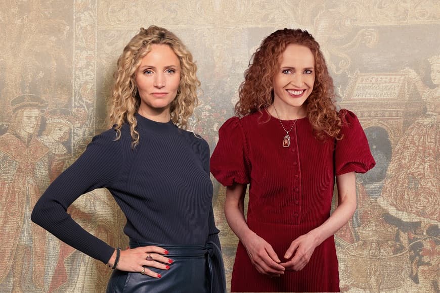 Suzannah and Kate posing with plain backdrop