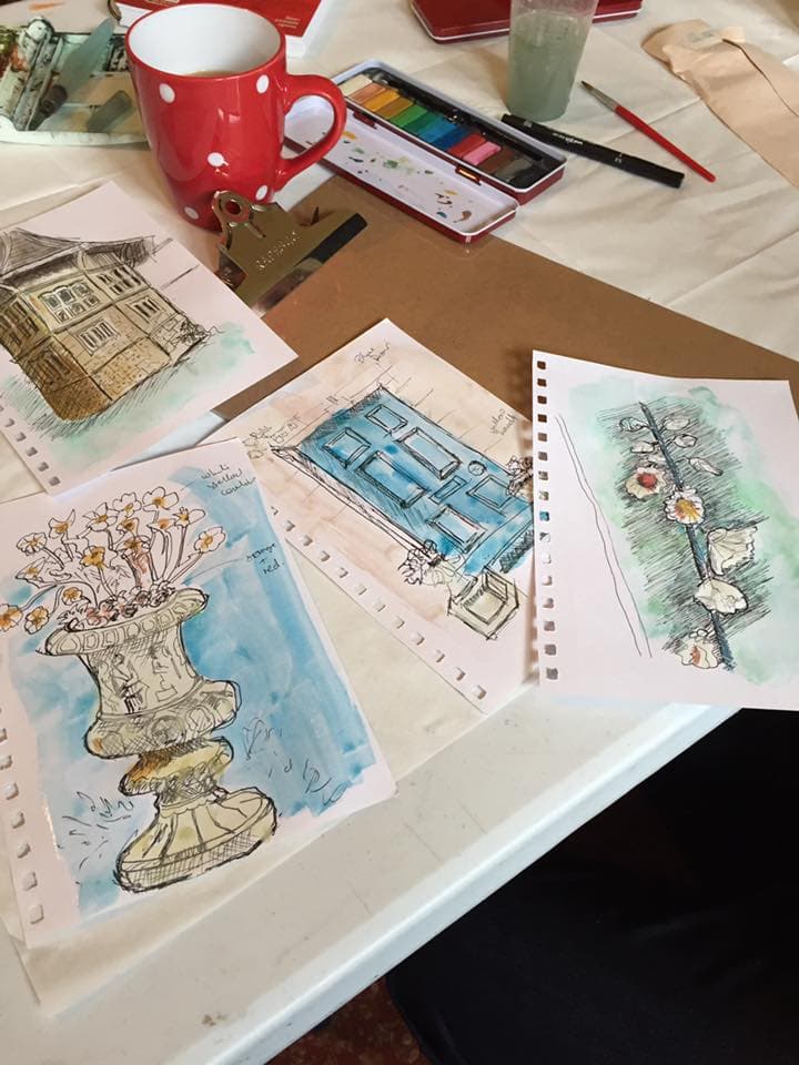 Watercolour sketches depicting a blue front door, flowers and a stone vase full of white and yellow flowers. 