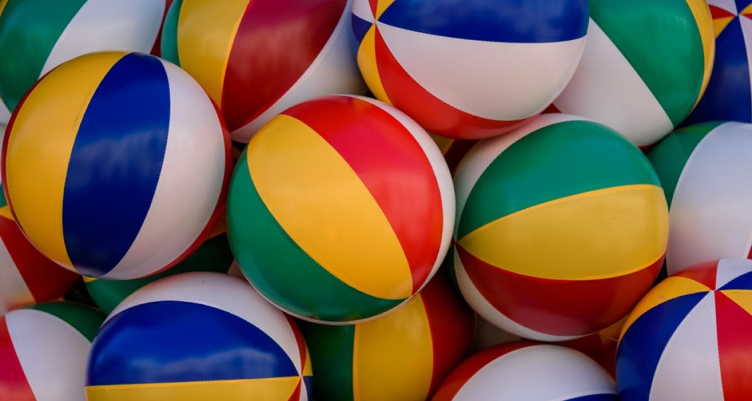 A vibrant pile of colourful beach balls.