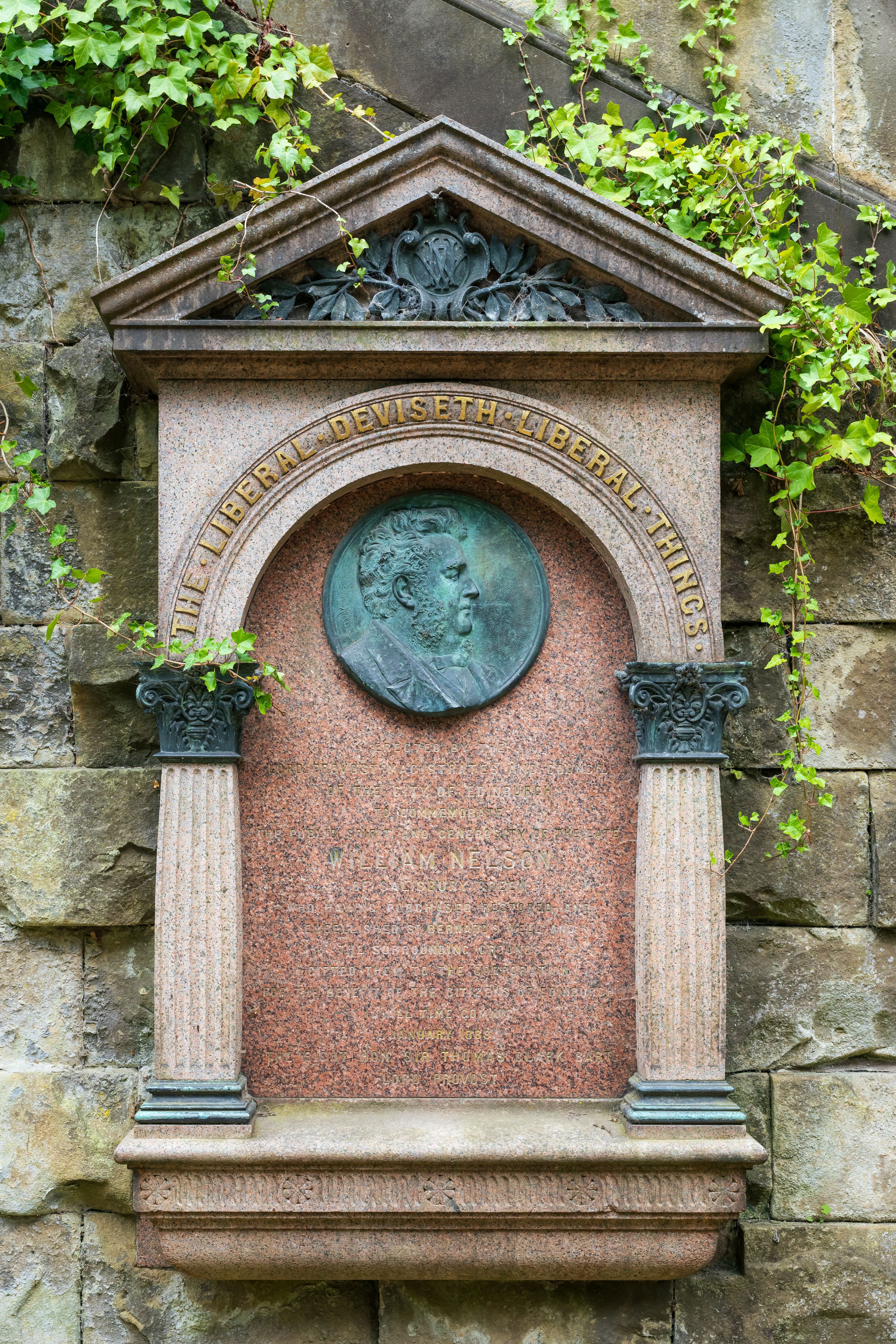 A rustic stone wall displaying a plaque, which contains text that highlights its significance or historical context.