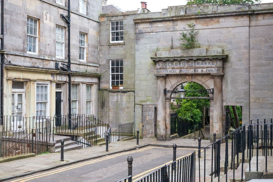 A street with an old archway at the end of it