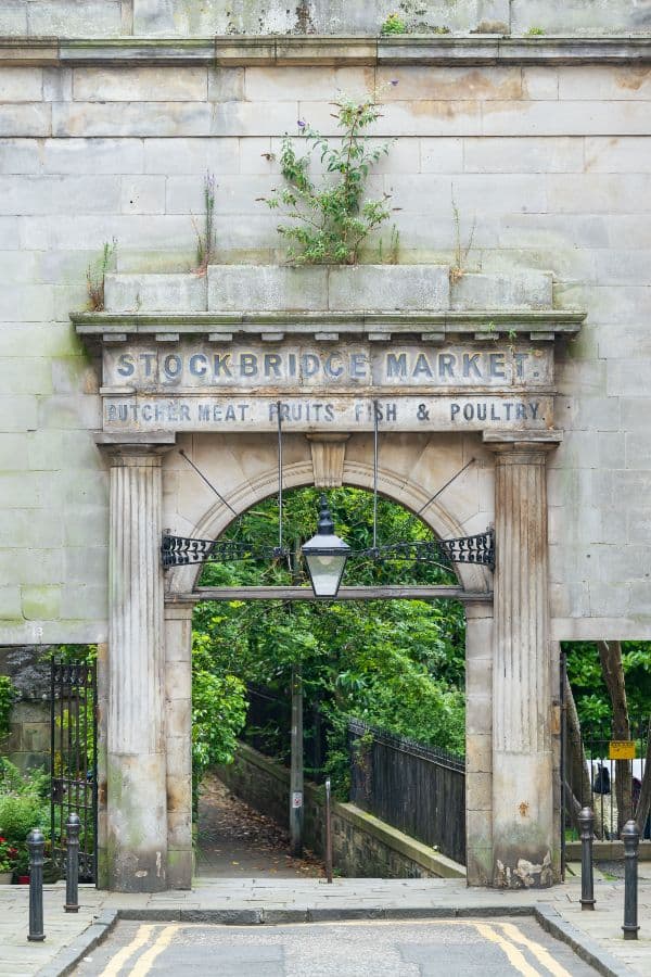 Symmetrically framed old archway with greenery behind it
