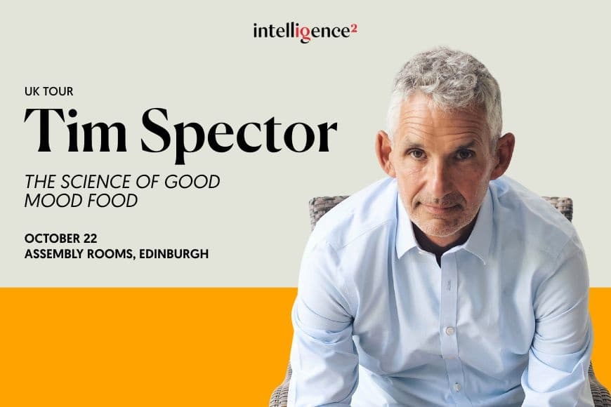 An photo of Tim Spector sat in a chair leaning forward 