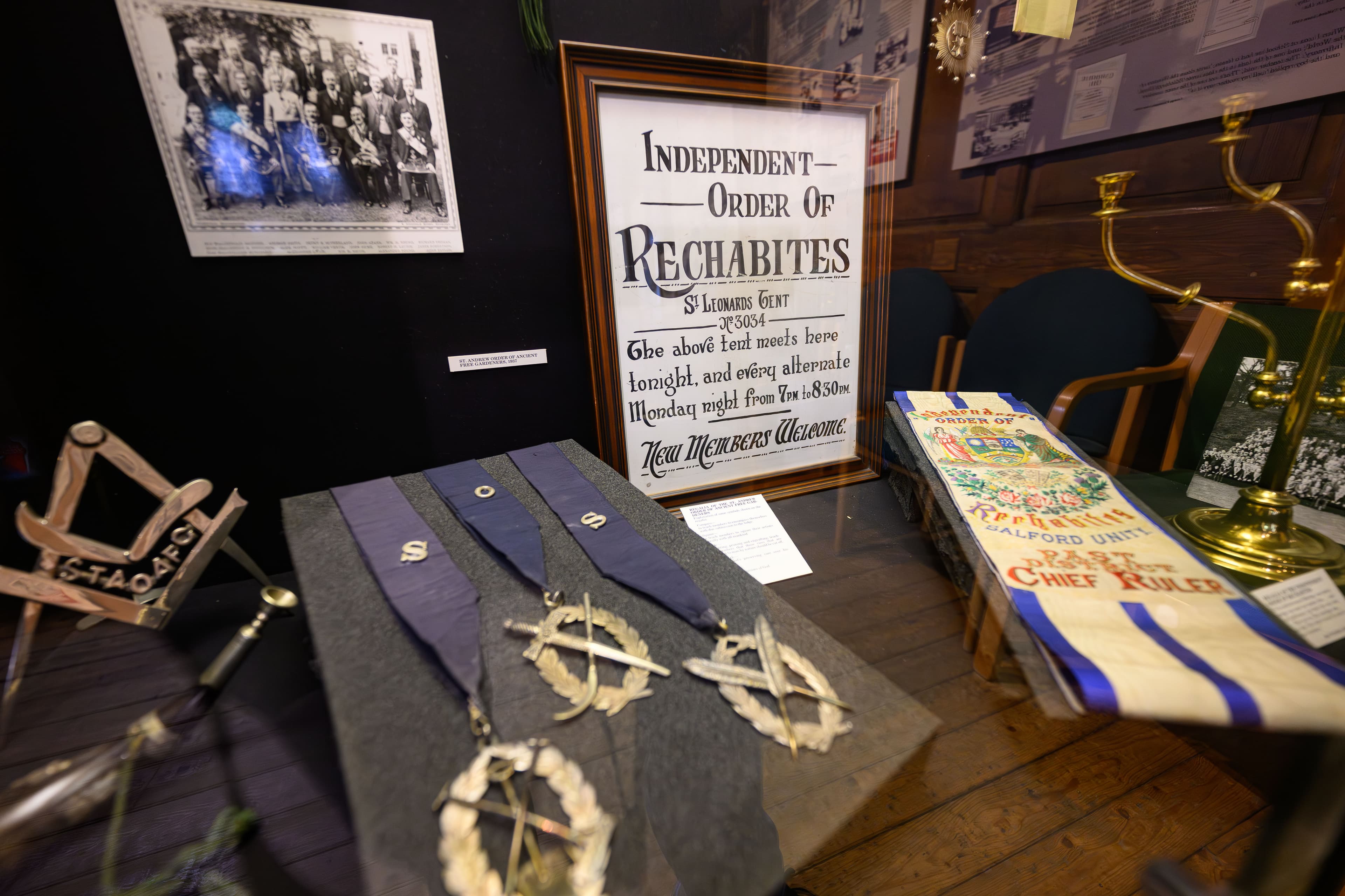 Masonic items arranged in a museum exhibit, highlighting the rich history and symbolism of Freemasonry.