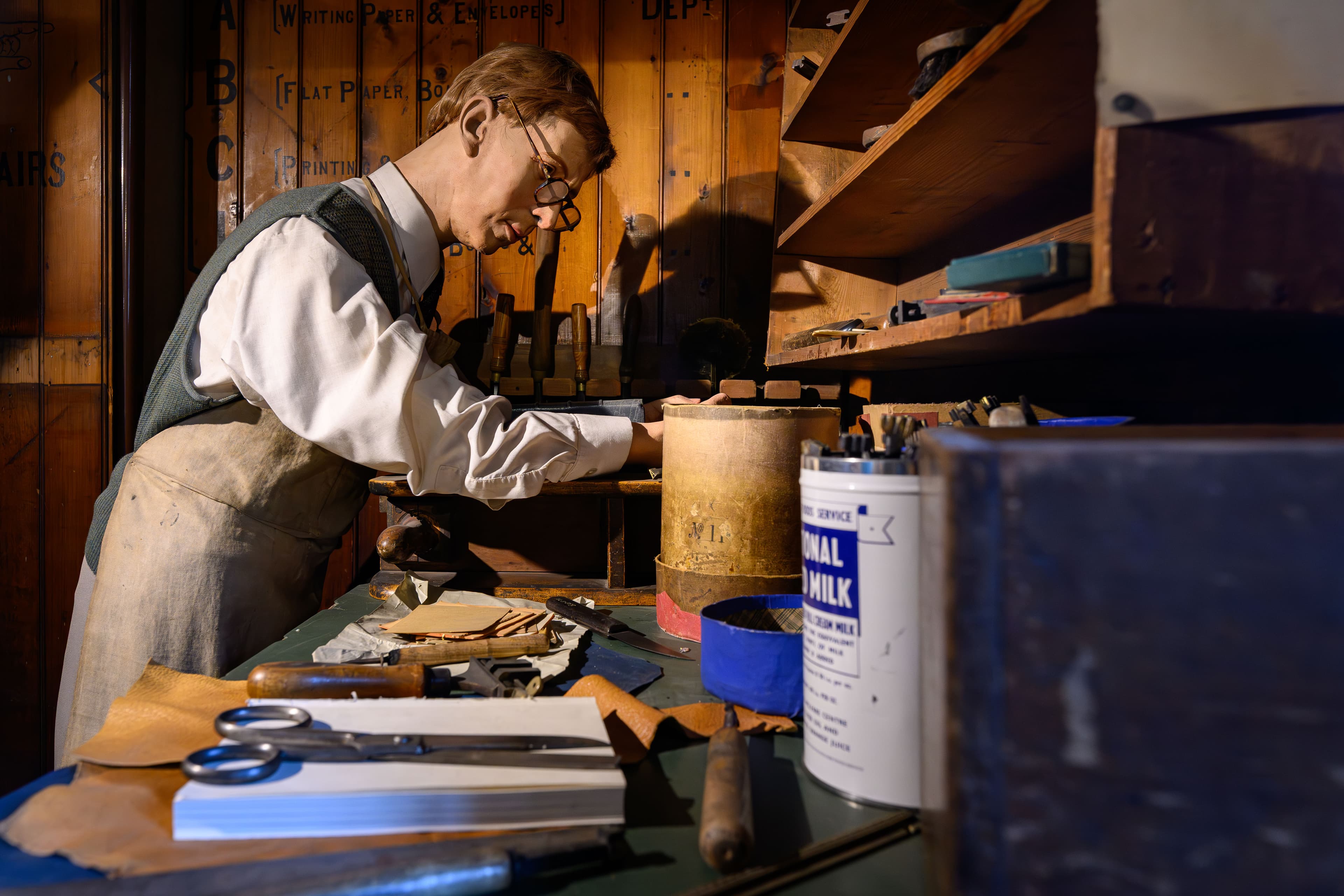 A man engaged in the process of making a leather shoe, demonstrating craftsmanship and attention to detail.