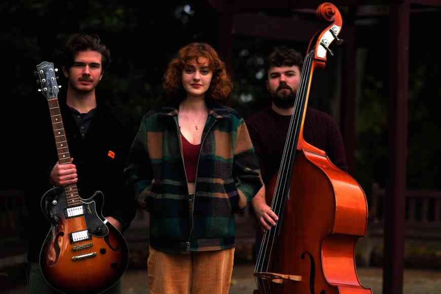 Photograph of musicians Cameron Duff holding double bass, Calum Steel holding guitar and Charlotte Stuart vocals, who are The Stone Combo.
