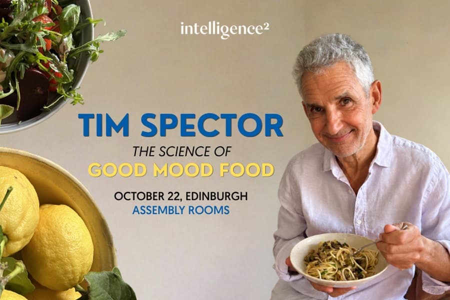 Image shows Tim Spector smiling and eating bowl of spaghetti
