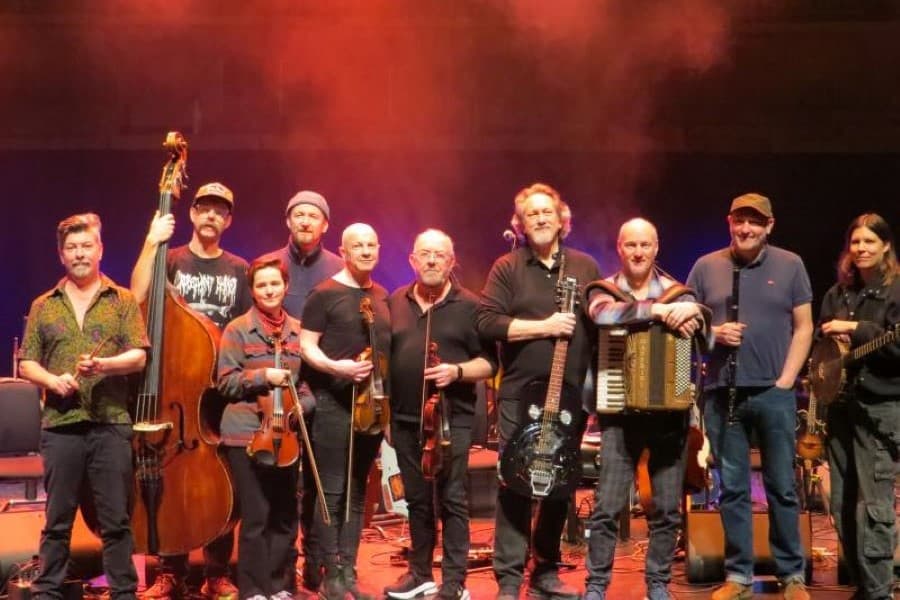 Photograph of Transatlantic Sessions house band gathered together on stage.